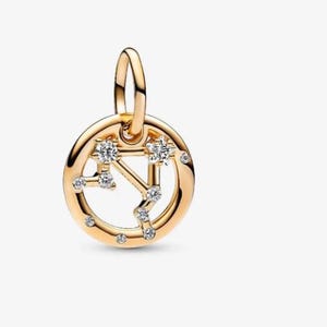 Könnte beinhalten: Ein runder Goldanhänger mit einem Sternbild-Design, das aus kleinen, klaren, funkelnden Steinen besteht. Der Anhänger verfügt über eine obere Öse zur Befestigung und zeigt eine Reihe verbundener Punkte, die ein Sternenmuster im Rahmen bilden.