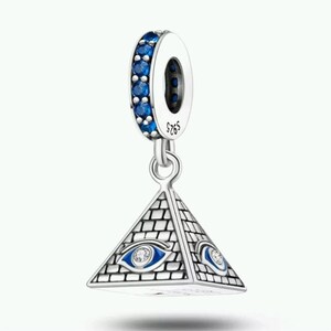 May include: A silver charm bead featuring a pyramid-shaped pendant with an engraved brick pattern and an eye motif on each side. The eye design includes blue enamel and a small clear stone. The top ring is set with blue stones and marked S925.