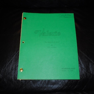 May include: A bright green screenplay script titled Valerie with the subtitle The Best of All Time by R.D. Cullinan dated October 23, 1985. The document is bound with two gold-colored metal fasteners on the left side and features handwritten text at the top.