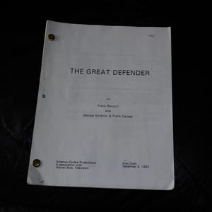 May include: A white script titled "THE GREAT DEFENDER" with text by Frank Renault and George Schenck & Frank Cardes. The script is held together with brass fasteners and is dated December 3, 1993.