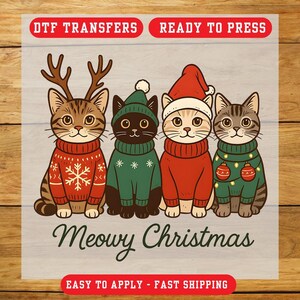 May include: A DTF transfer sheet featuring four illustrated cats wearing holiday sweaters and hats. The text reads DTF TRANSFERS, READY TO PRESS, Meowy Christmas, and EASY TO APPLY - FAST SHIPPING. The cats are brown, black, and tan.