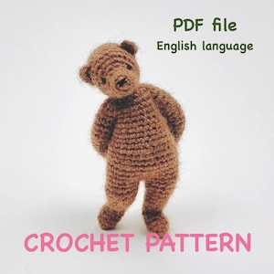 May include: A brown crocheted teddy bear stands on a white background. The bear is made of textured yarn and has a small head, arms, and legs. Text on the image reads "PDF file English language" and "CROCHET PATTERN".