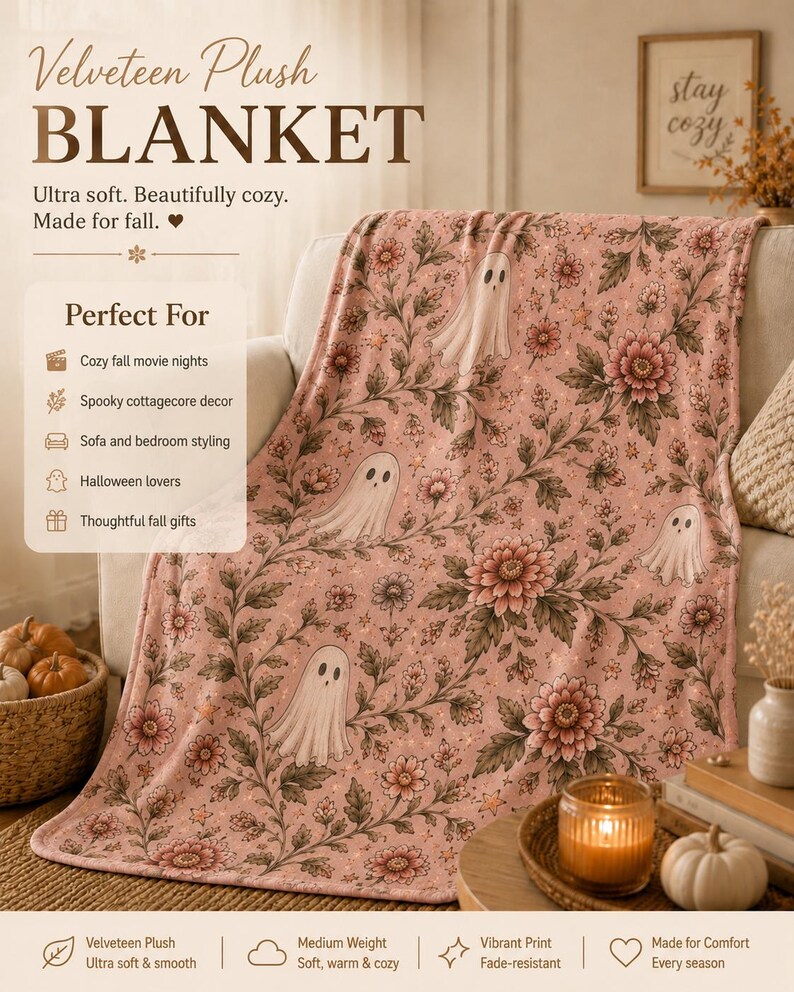 May include: A velveteen plush blanket featuring a repeating pattern of white ghosts, pink flowers, and green foliage on a light pink background. The text on the blanket includes Velveteen Plush BLANKET, Ultra soft. Beautifully cozy. Made for fall.