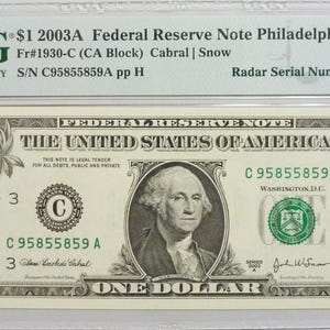 May include: A graded 2003A one-dollar Federal Reserve Note from Philadelphia, encapsulated in a PMG plastic holder. The bill features George Washington, the text "The United States of America," and a radar serial number C95855859A, graded 66 EPQ.