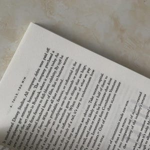 May include: Open book page with printed text. The text includes the title "6. TAILS. YOU WIN" and paragraphs discussing business and investment strategies. The page is white with black text.