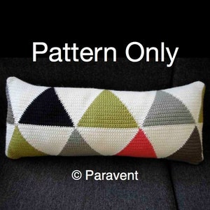 May include: A crochet cushion with a geometric pattern of triangles in black, white, green, red, and brown. The cushion is on a dark grey sofa. The text "Pattern Only" is above the cushion and the text "© Paravent" is below the cushion.