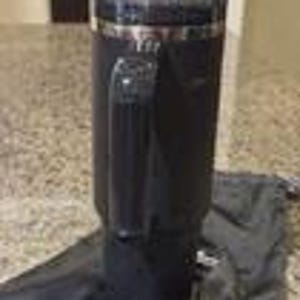 Pu&ograve; includere: Un alto bicchiere termico nero opaco dotato di una robusta impugnatura verticale sul lato, un coperchio in plastica trasparente con bordo argentato metallizzato e una base affusolata. Il bicchiere &egrave; accompagnato da una sacca in tessuto nero.