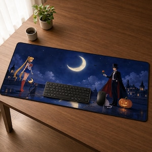 May include: A rectangular desk mat featuring a night scene with a crescent moon, a character with blonde hair in a blue and white outfit, and a character in a black tuxedo and cape holding a rose. A black keyboard and mouse sit on the mat.