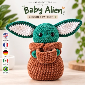 Puede incluir: Un patrón de ganchillo para un Baby Alien con cabeza verde, orejas grandes, ojos negros y túnica marrón. El texto dice LINDA CREATIVE CO, Baby Alien y CROCHET PATTERN. Una columna vertical de banderas indica las opciones de idioma disponibles.