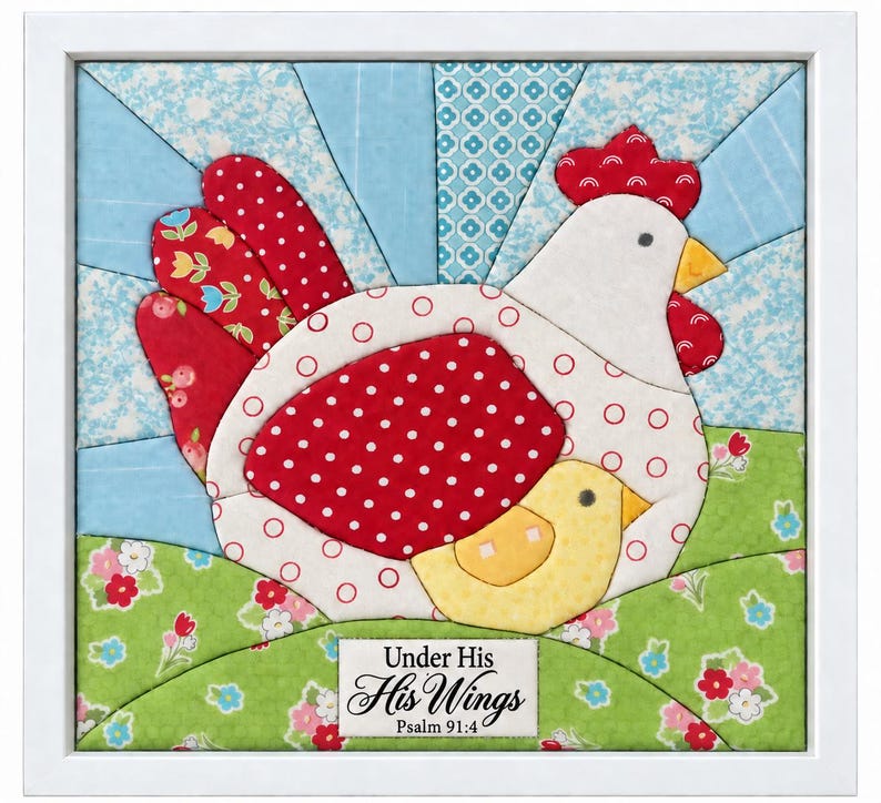 May include: A framed fabric quilt art piece featuring a white hen with red polka dots and a small yellow chick. The background shows a blue sunburst pattern and a green floral meadow. A white label at the bottom reads Under His His Wings Psalm 91:4.