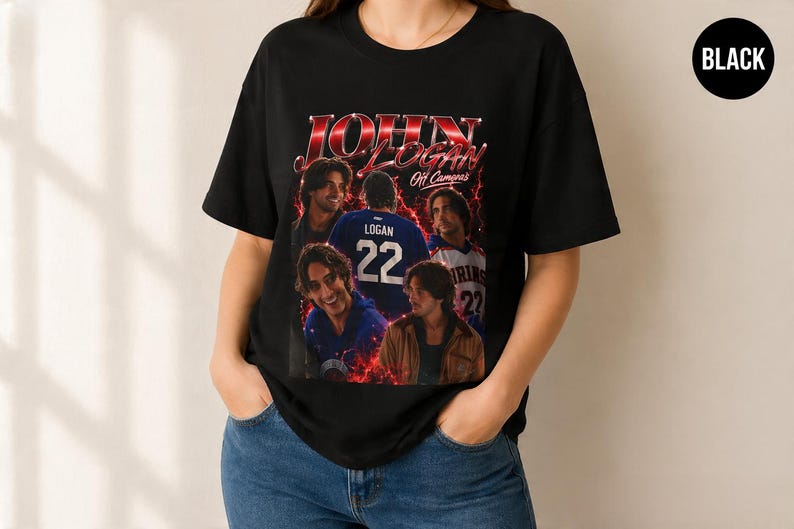 Pode incluir: Uma t-shirt preta de manga curta com uma impress&atilde;o gr&aacute;fica de John Logan e o texto 'JOHN LOGAN Off Camera'. O design inclui v&aacute;rias imagens de uma pessoa, uma camisola com o n&uacute;mero 22 e efeitos de rel&acirc;mpagos vermelhos na frente.