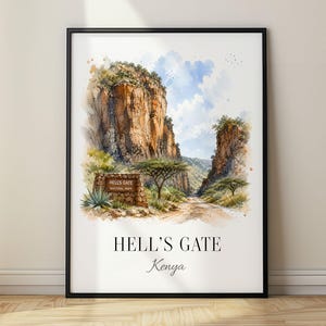 May include: A framed watercolor art print depicting the landscape of Hell's Gate National Park in Kenya. The image features tall rocky cliffs, a dirt path, acacia trees, and a stone park sign. The text reads HELL'S GATE and Kenya below.