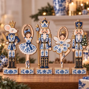 May include: A set of five decorative wooden figurines featuring a mouse soldier, a ballerina, a nutcracker with a staff, a fairy ballerina, and a nutcracker holding a tree. Each figure is painted in blue and white floral patterns with gold accents.