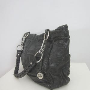 Cartera de cuero negra para mujer The Sak, con cadena plateada, trenzada, doble asa, plisada, con bolsillo, estilo retro, suave y espaciosa