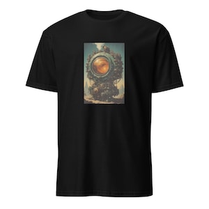 May include: Black t-shirt featuring a detailed, colorful illustration of a steampunk-style machine with a large, orange-yellow lens. The artwork is centered on the shirt, set against a backdrop of a desert landscape and a blue sky.