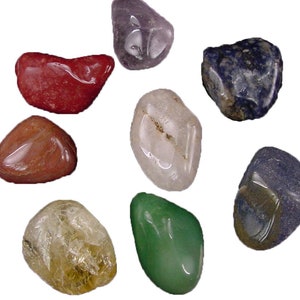 May include: Seven tumbled stones in various colors, including red, orange, yellow, green, blue, purple, and clear. The stones are smooth and polished.