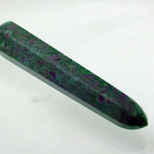 May include: A green and purple gemstone wand with a pointed tip. The wand is smooth and polished.