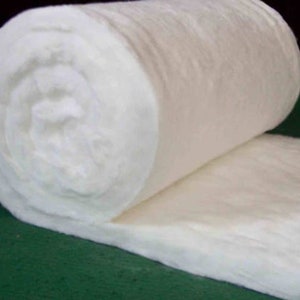 May include: A roll of white cotton batting, a soft and fluffy material used for stuffing, quilting, and crafts.