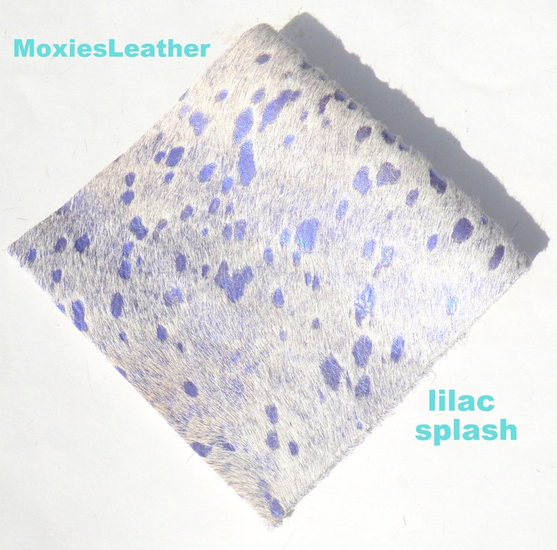 May include: White cowhide leather with a lilac splash pattern. MoxiesLeather.