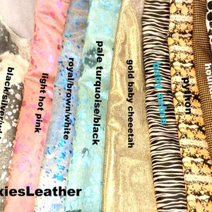 May include: A collection of different colored and patterned leather swatches. The swatches include: royal/white, gold sunshine, black/silver/white, light hot pink, royal/brown/white, pale turquoise/black, gold baby cheetah, baby zebra, python, hounds tooth, and white giraffe.