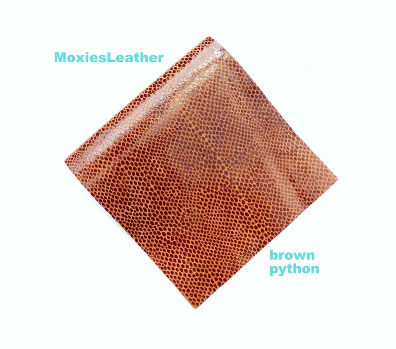 May include: A close-up of a brown python leather with a textured surface. The leather is a rich brown colour with a subtle sheen. "MoxiesLeather" and "brown python" are written in white text on the image.
