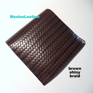 May include: Brown leather with a shiny braided texture. The leather is labeled "MoxiesLeather" and "brown shiny braid".