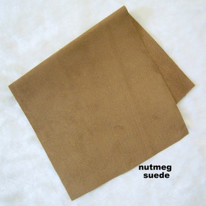 May include: A piece of nutmeg suede fabric. The fabric is a light brown color.