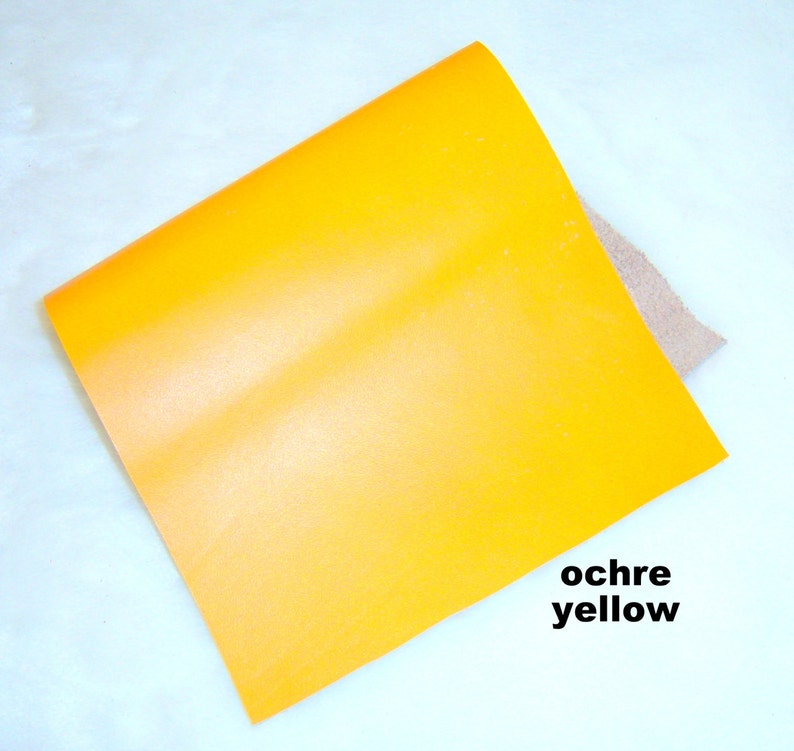 May include: A square piece of ochre yellow paper.