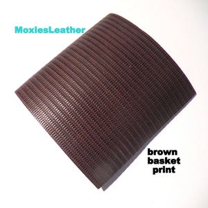 May include: Brown leather with a basket weave pattern.  The leather is textured and has a subtle sheen.