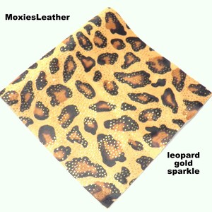 May include: Leopard print fabric with gold sparkle.  The fabric is a light brown with black spots and gold glitter.