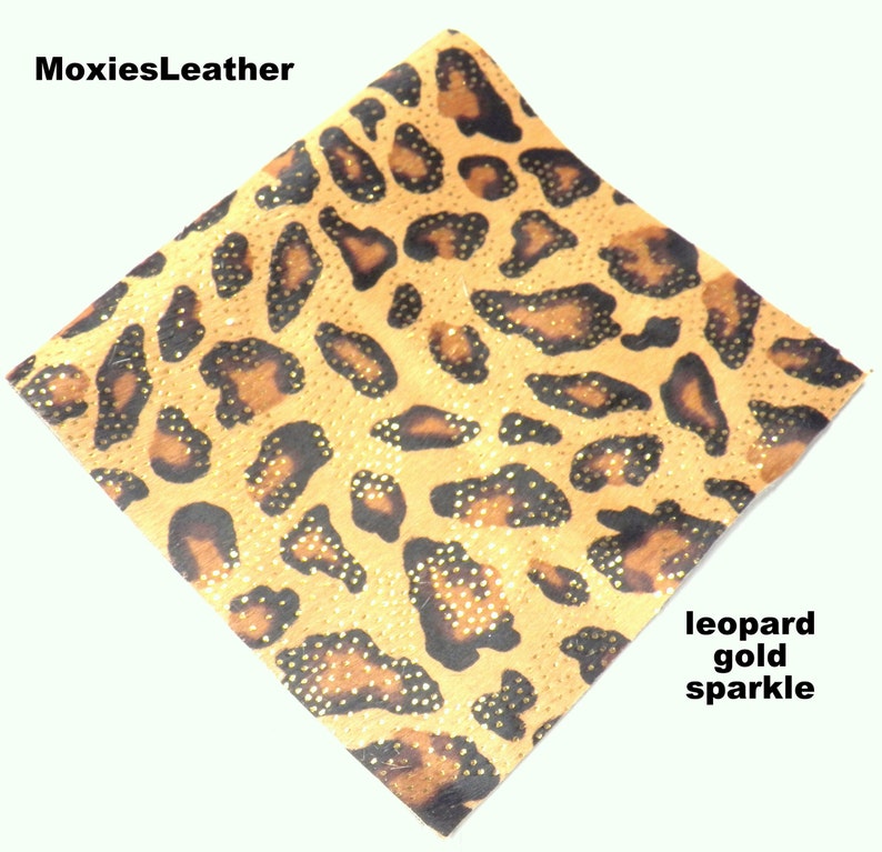 May include: Leopard print fabric with gold sparkle.  The fabric is a light brown with black spots and gold glitter.