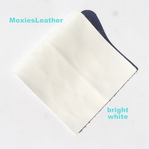 White leather pieces , leather scraps , leather remnants , earrings leather , leather sheets .
