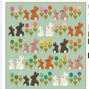 May include: A quilt with a repeating pattern of bunnies and flowers in various colors. The bunnies are brown, tan, white, and black, with white fluffy tails. The flowers are pink, orange, yellow, and blue, with green stems and leaves. The background is a light green.