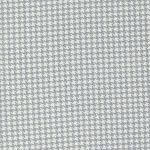 May include: A white fabric with a gray and white houndstooth pattern.