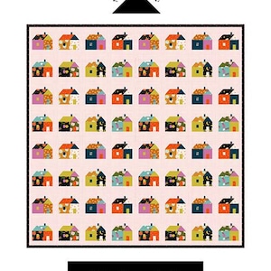 May include: A colorful quilt featuring a repeating pattern of small houses in various colors, including blue, orange, and yellow, set against a pink background. The quilt measures 70" x 72". The text "Little House Quilt" is displayed at the bottom.