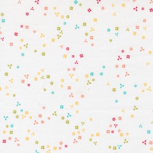 May include: White fabric with a scattered pattern of small, colorful flowers. The flowers are in shades of pink, yellow, green, and blue. The fabric has a slightly textured appearance.