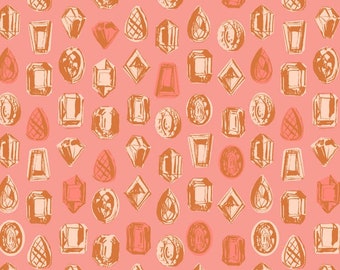 May include: A pink fabric with a repeating pattern of orange gemstones in various shapes and sizes. The fabric is measured with a ruler in inches.