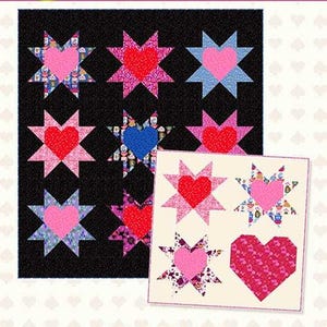 May include: A quilt pattern featuring star and heart designs in pink, red, and blue on a black background. The pattern is titled "Wonderland" and includes the Copper Kettle Quilt Company logo.