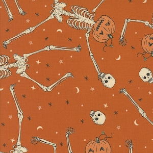 May include: Orange fabric with a repeating pattern of skeletons, pumpkins, and stars. The skeletons are in various poses, and the pumpkins have jack-o'-lantern faces. The background is a solid orange color.