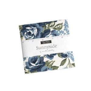 May include: A fabric square with a blue and green floral pattern. The fabric is labeled "Sunnyside by Camille Roskelley" and "Moda Fabrics & Supplies".