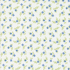 May include: White fabric with a repeating pattern of small blue flowers and green leaves.