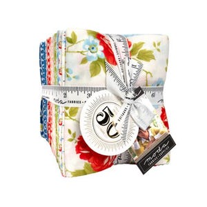 May include: A stack of floral fabric squares tied with a white ribbon printed with measurements. The fabric features red roses, blue flowers, and green leaves on a white background. A round tag reads "50 Years". A black tag reads "moda fabrics supplies".