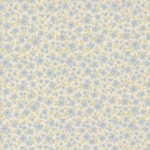May include: A white fabric with a repeating pattern of small blue flowers and green leaves.