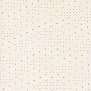 May include: Cream-colored fabric with a repeating pattern of small, orange-brown diamond shapes and dots. The diamonds are evenly spaced across the surface, creating a subtle, textured appearance. The fabric has a soft, matte finish.