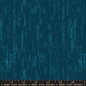 May include: Teal blue fabric with a textured, distressed look. The fabric has a subtle, speckled pattern that resembles wood grain. The fabric is perfect for quilting, crafts, and home decor projects.
