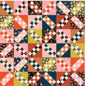 May include: A patchwork quilt with a repeating pattern of squares and diagonal rectangles. The quilt features a variety of colors, including pink, orange, green, and navy. Some squares have a checkerboard pattern, while others have floral or fruit designs.