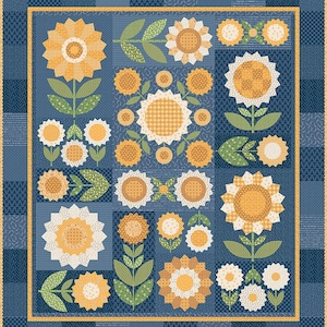 May include: A rectangular quilt featuring a patchwork design of yellow and white sunflowers with green leaves on a dark blue background. The quilt is framed by a thin yellow border and a wider outer border made of various blue patterned fabric squares.