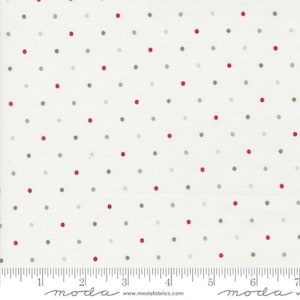 May include: White fabric with a repeating pattern of red, gray, and green polka dots. The dots are evenly spaced across the surface. A ruler is printed along the bottom edge, with the word "moda" and a website address.
