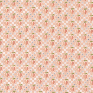 May include: A pink fabric with a repeating pattern of peach fruit and white flowers. The peaches are stylized and have a green leaf on top. The flowers are small and have a white center with a blue dot.