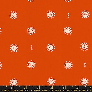 May include: Orange fabric with a white repeating pattern of stylized suns. The fabric has a textured surface and the suns have a simple face design. The text "RUBY STAR SOCIETY" is printed at the bottom of the fabric.